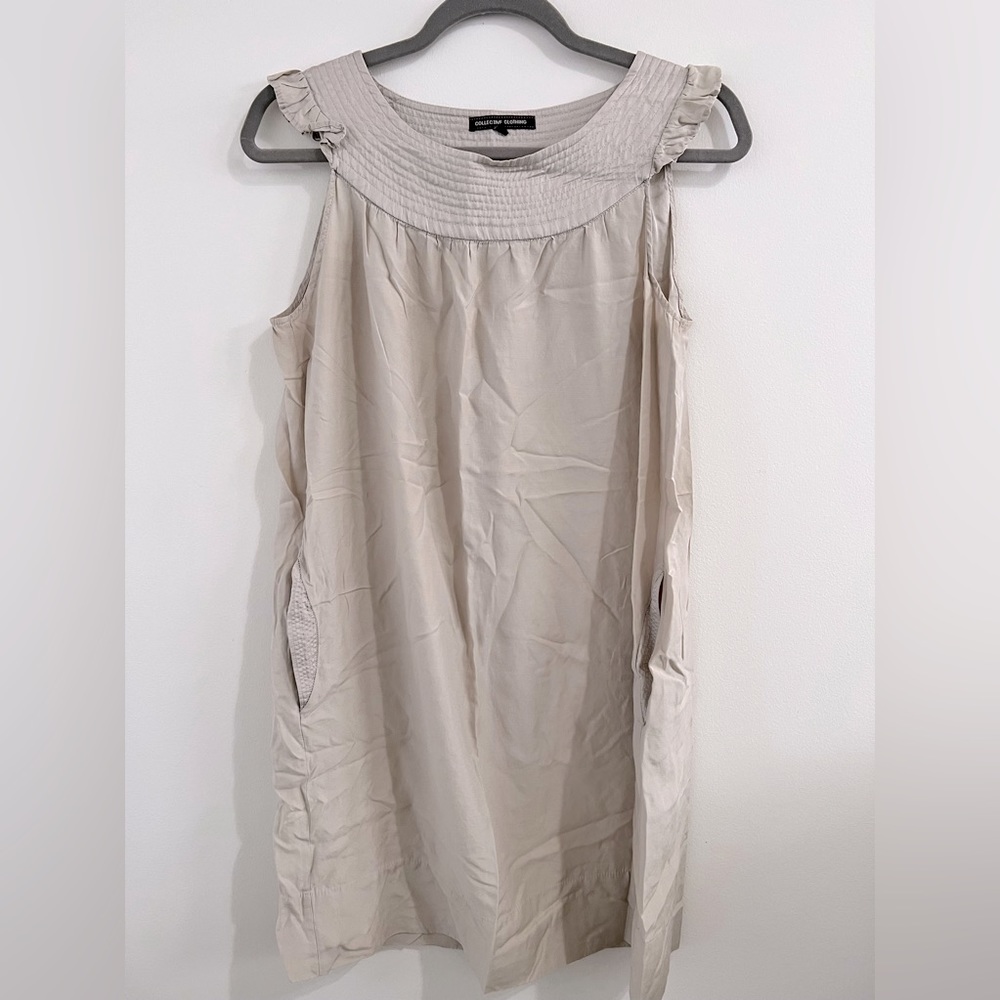 Collective Clothing. Light gray/tan w/silver stitching around neck and pockets.